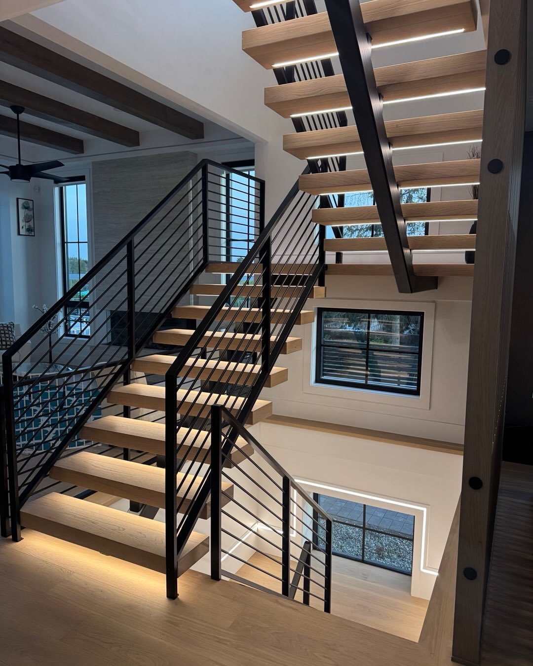 Open riser staircase with black railing