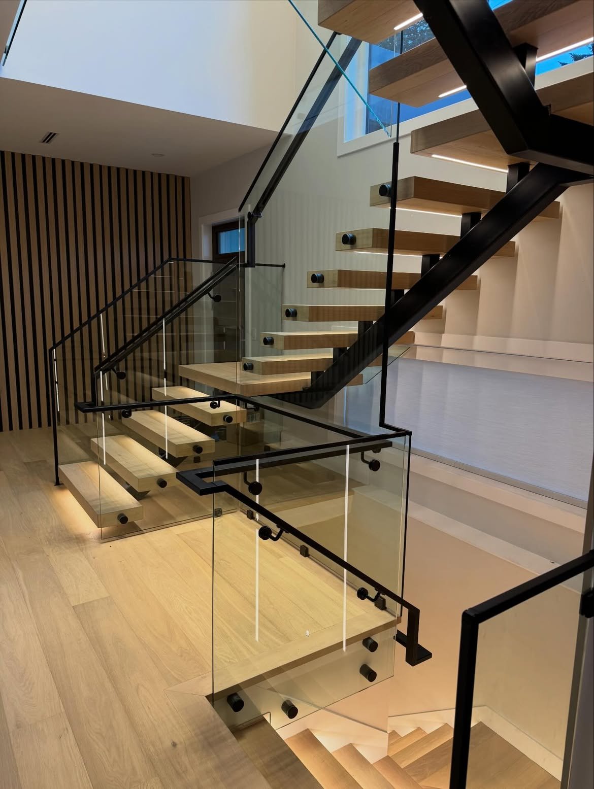 Glass staircase with warm LED lighting