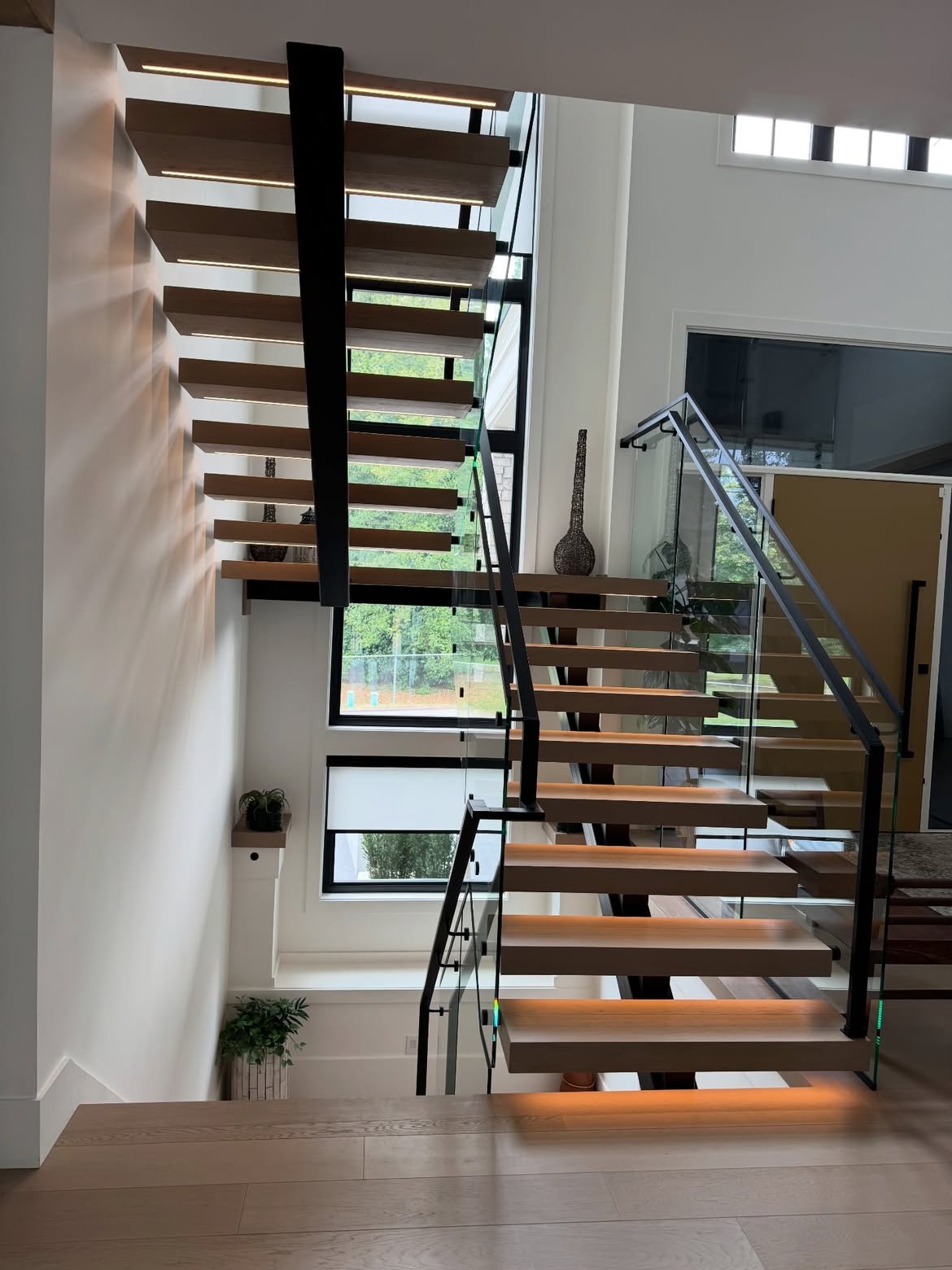 Open riser staircase with tall windows