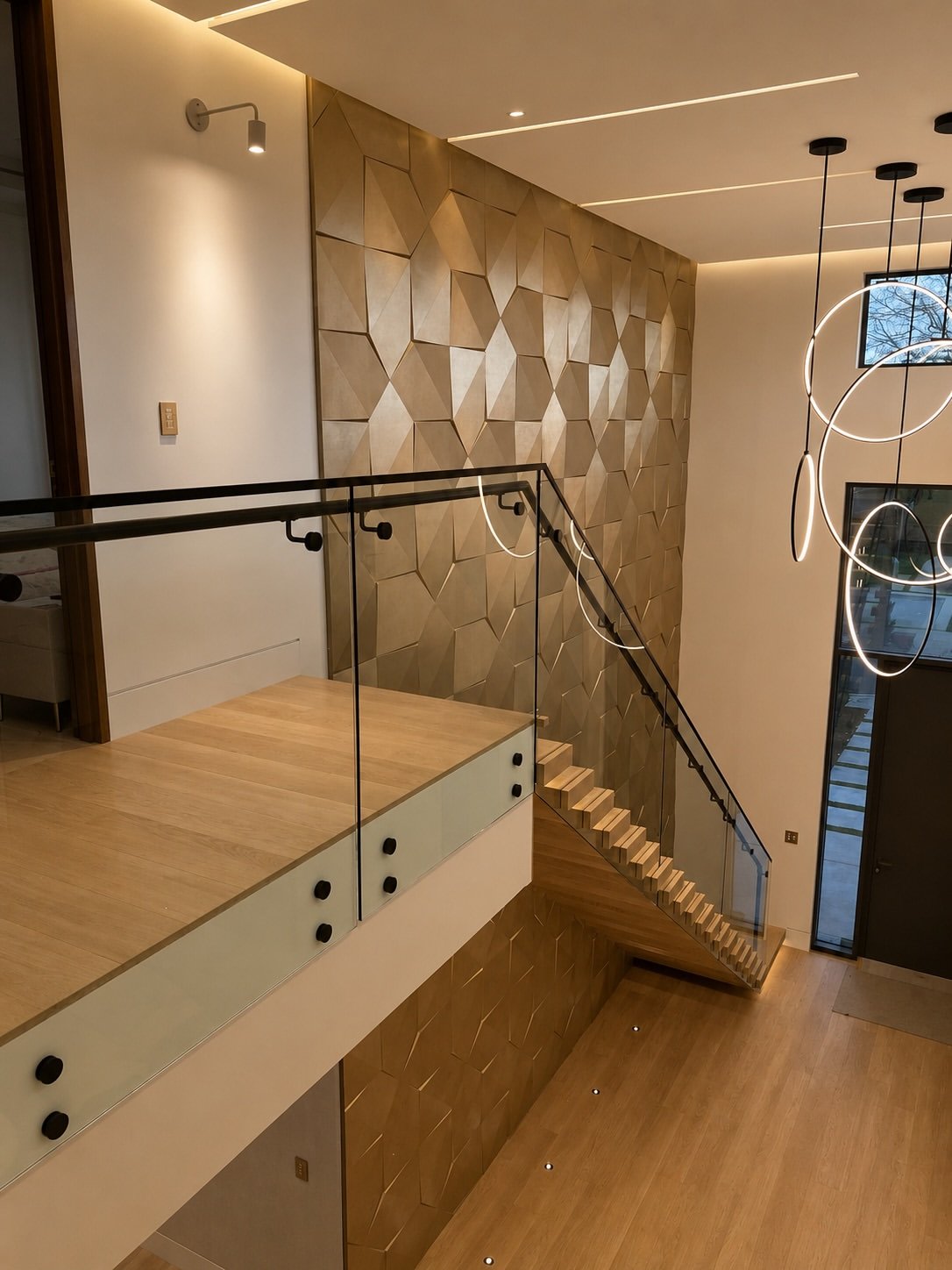 Feature wall staircase with suspended ring lights